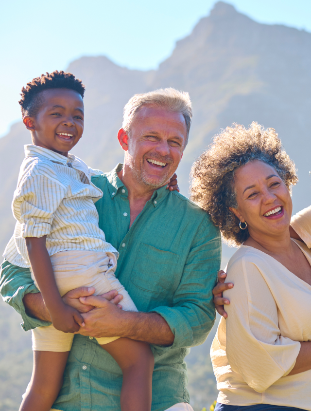 Portrait Of Three Generation Family Laughing And Smiling Standing Outdoors In Countryside