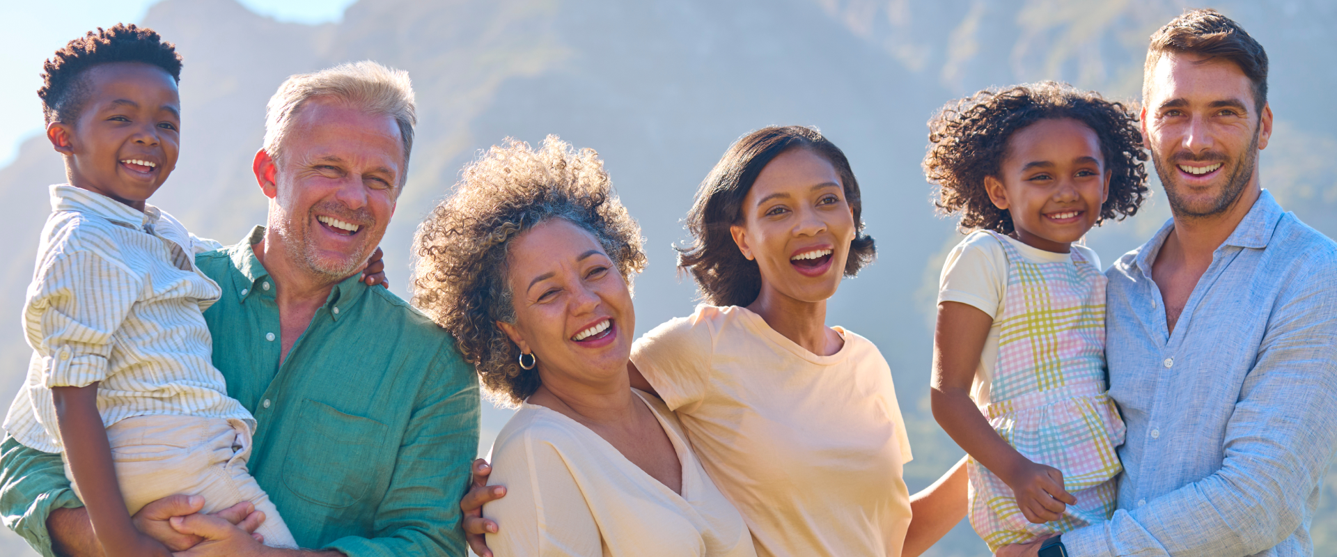Portrait Of Three Generation Family Laughing And Smiling Standing Outdoors In Countryside